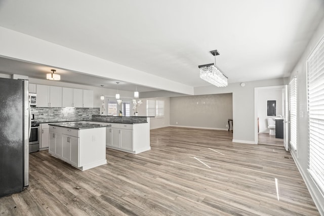 kitchen featuring plenty of natural light, pendant lighting, and appliances with stainless steel finishes