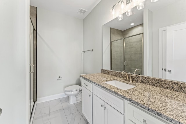 bathroom featuring vanity, an enclosed shower, and toilet