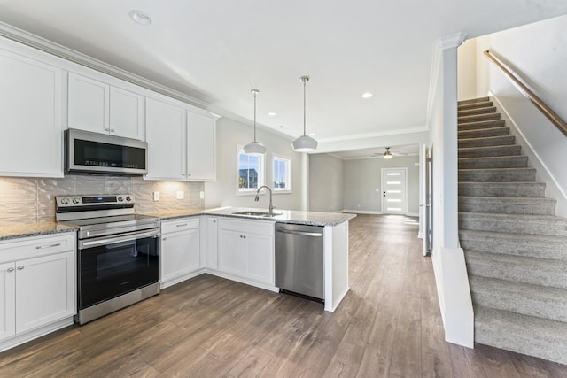 kitchen with ceiling fan, white cabinetry, and appliances with stainless steel finishes