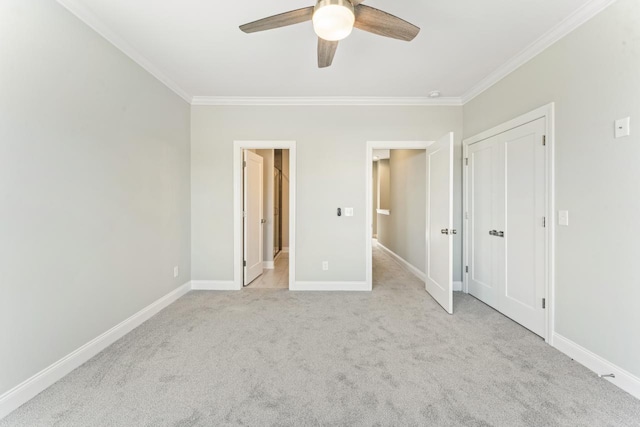 unfurnished bedroom featuring ceiling fan, light colored carpet, and ornamental molding