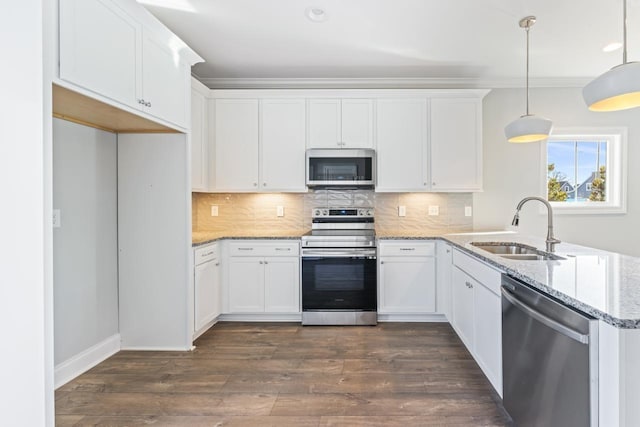 kitchen with sink, white cabinets, hanging light fixtures, and appliances with stainless steel finishes