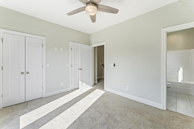 unfurnished bedroom with ceiling fan, light carpet, and connected bathroom