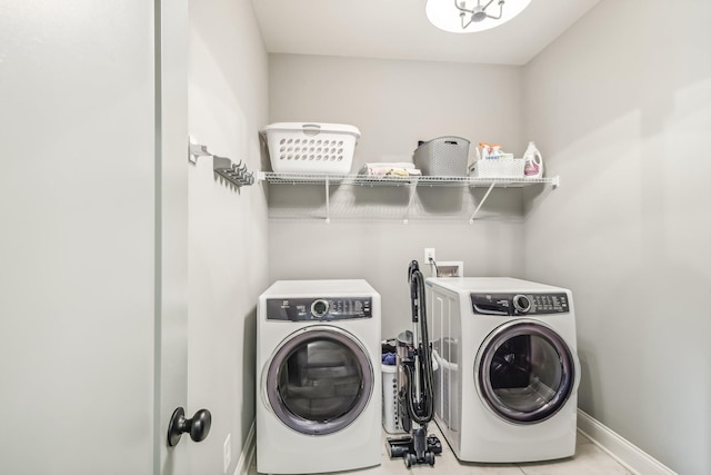 washroom with washing machine and dryer and light tile patterned floors