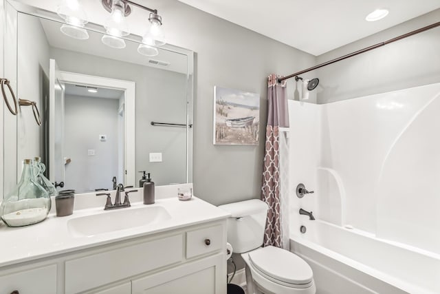 full bathroom featuring vanity, shower / bath combination with curtain, and toilet