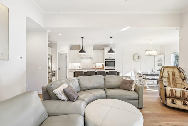 living room featuring light hardwood / wood-style floors and ornamental molding