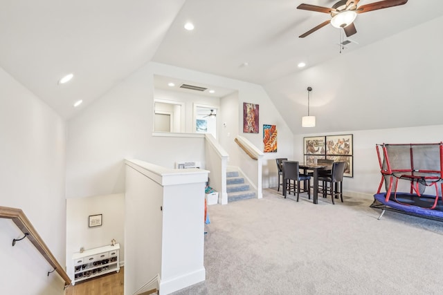 recreation room with carpet floors, vaulted ceiling, and ceiling fan