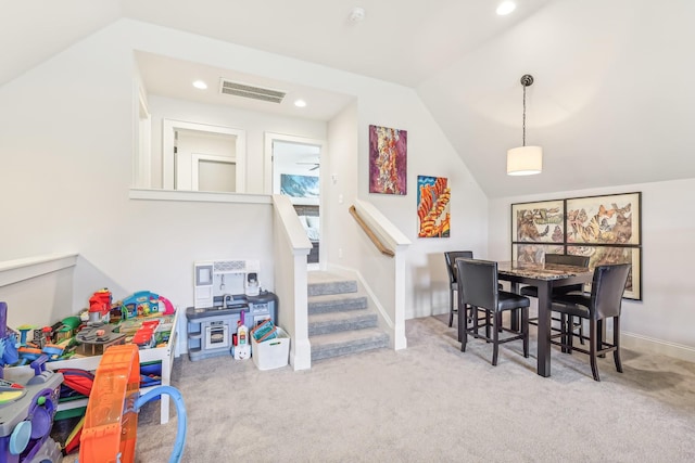 recreation room featuring light carpet and vaulted ceiling