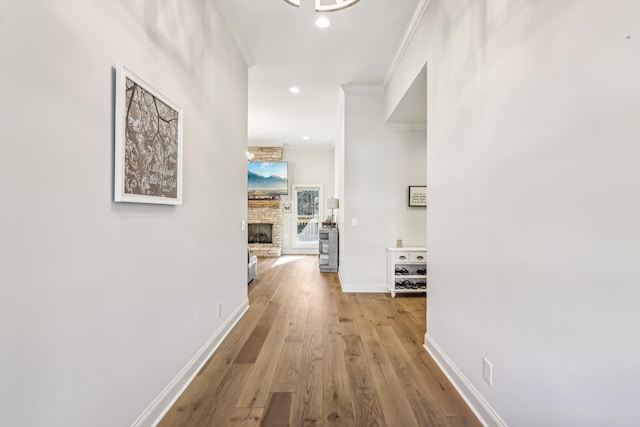 corridor featuring light hardwood / wood-style floors and ornamental molding