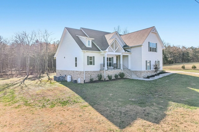 craftsman-style home with covered porch, central AC, and a front lawn