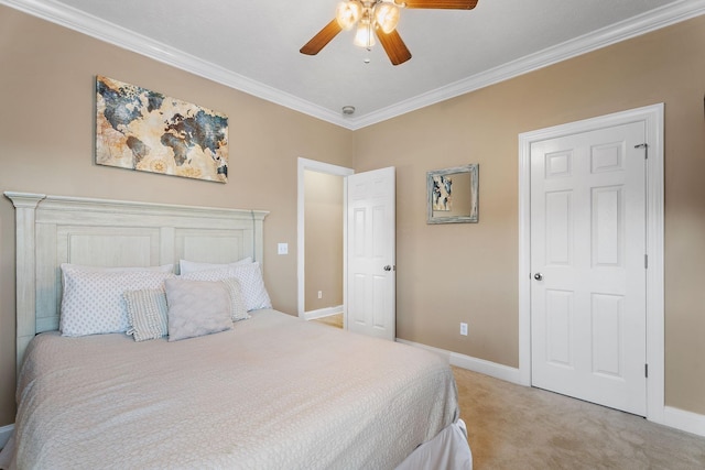 carpeted bedroom featuring ceiling fan and crown molding