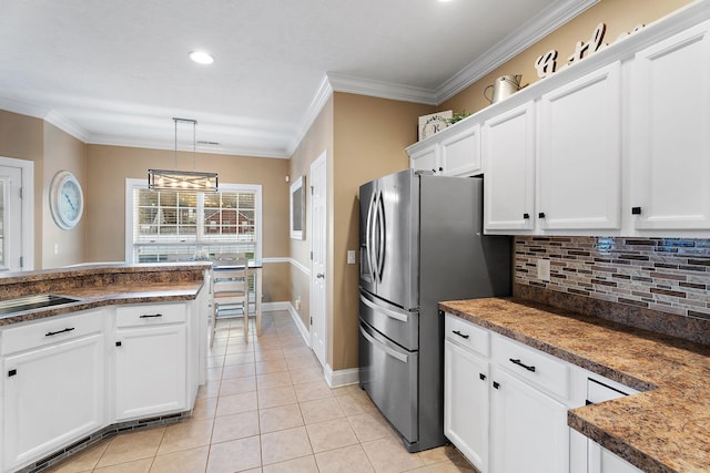 kitchen with backsplash, stainless steel fridge with ice dispenser, white cabinets, and pendant lighting