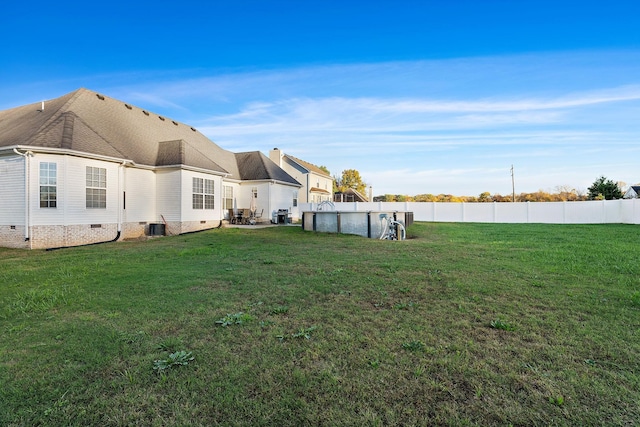 view of yard featuring cooling unit and a fenced in pool