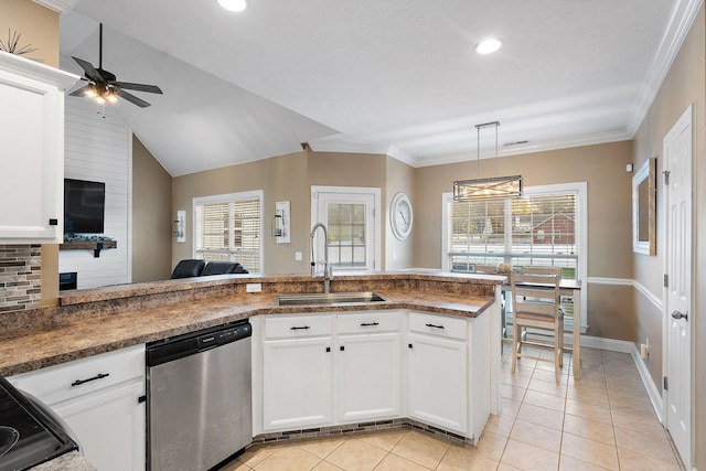 kitchen featuring dishwasher, lofted ceiling, sink, decorative light fixtures, and white cabinetry