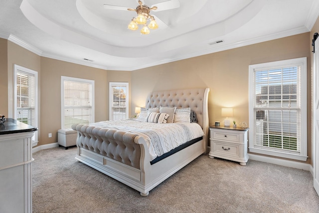 bedroom featuring light carpet, a tray ceiling, ceiling fan, and ornamental molding