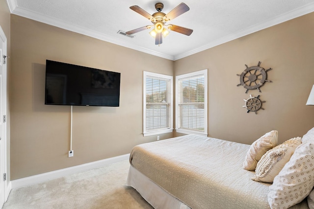 bedroom featuring light carpet, a textured ceiling, ceiling fan, and crown molding