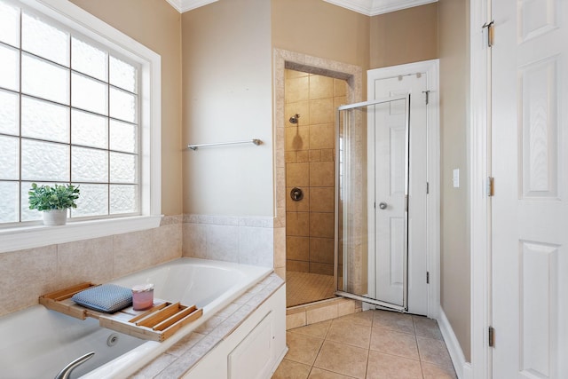 bathroom with tile patterned floors, a healthy amount of sunlight, and crown molding