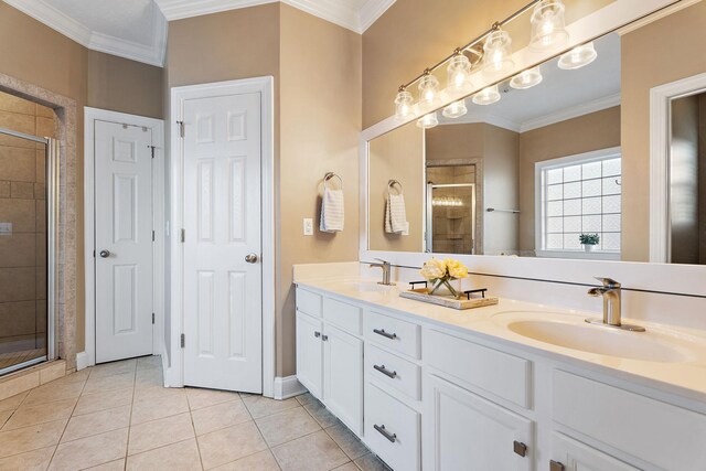 bathroom with tile patterned flooring, vanity, a shower with door, and crown molding