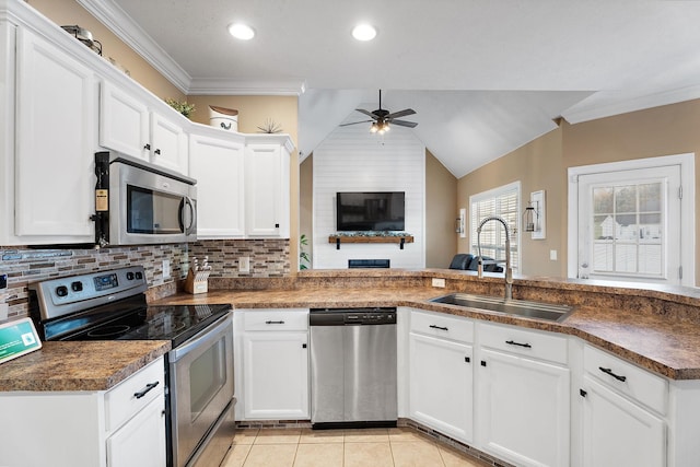 kitchen with white cabinetry, sink, ceiling fan, vaulted ceiling, and appliances with stainless steel finishes