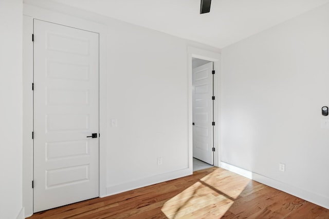 unfurnished bedroom featuring hardwood / wood-style floors and ceiling fan