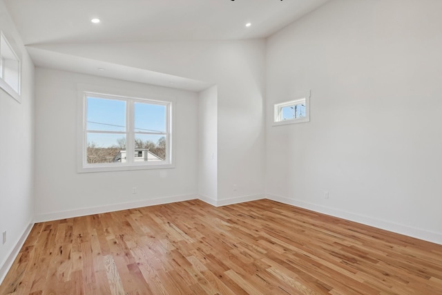 empty room featuring light hardwood / wood-style floors and high vaulted ceiling