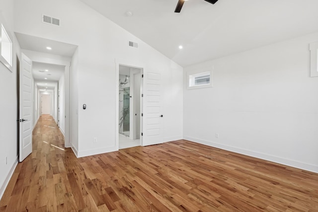 unfurnished room featuring high vaulted ceiling, light hardwood / wood-style flooring, and ceiling fan