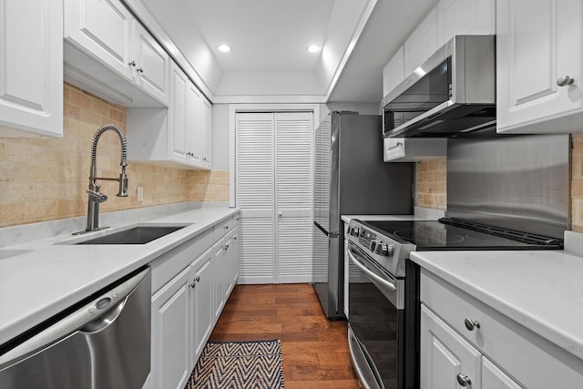 kitchen featuring white cabinetry, sink, stainless steel appliances, tasteful backsplash, and dark hardwood / wood-style flooring