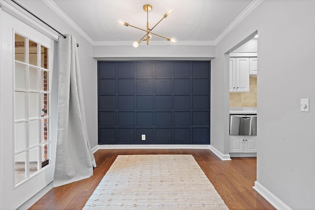 unfurnished dining area with an inviting chandelier, dark hardwood / wood-style floors, and ornamental molding