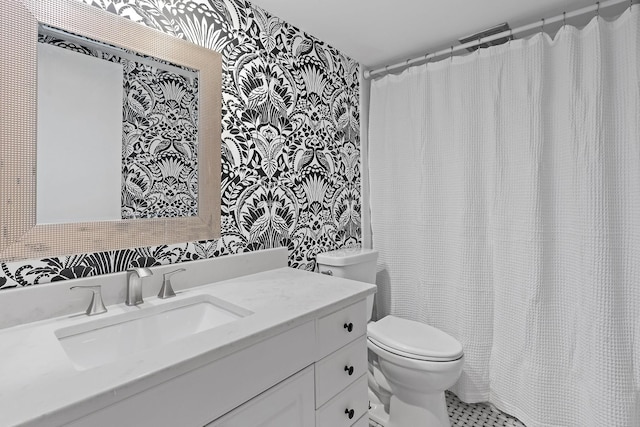 bathroom featuring tile patterned flooring, vanity, and toilet