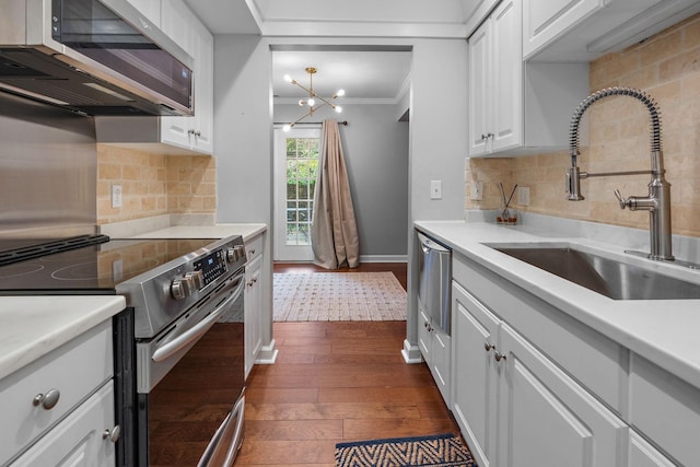 kitchen featuring backsplash, sink, dark hardwood / wood-style flooring, white cabinetry, and stainless steel appliances