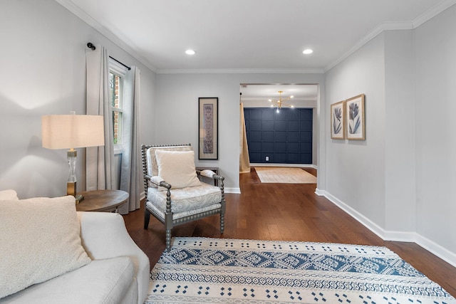 living area with a chandelier, crown molding, and dark wood-type flooring