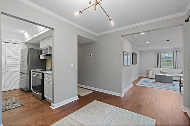 kitchen with backsplash, white cabinetry, dark hardwood / wood-style flooring, and stainless steel appliances