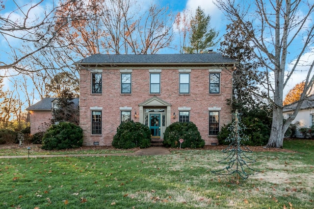 colonial inspired home with a front lawn