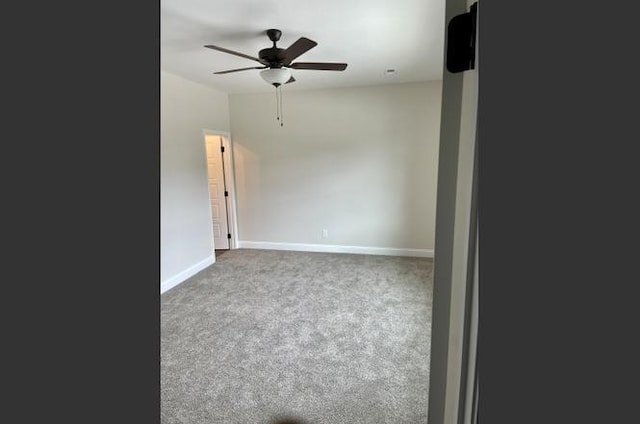 spare room with carpet floors and ceiling fan