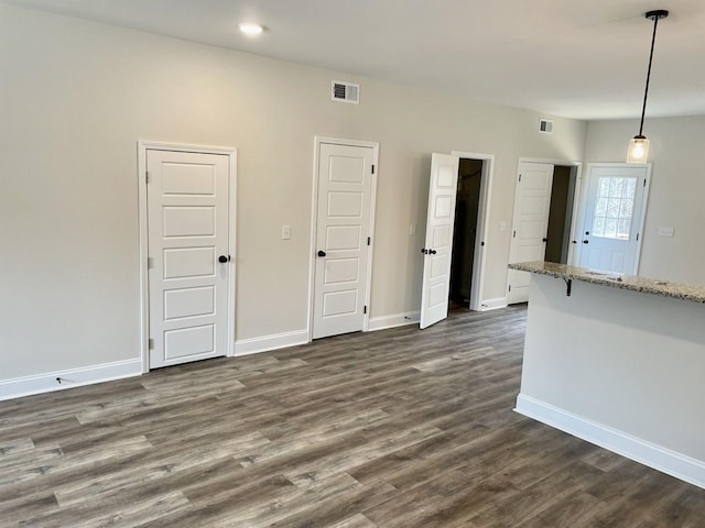 unfurnished living room featuring dark hardwood / wood-style flooring