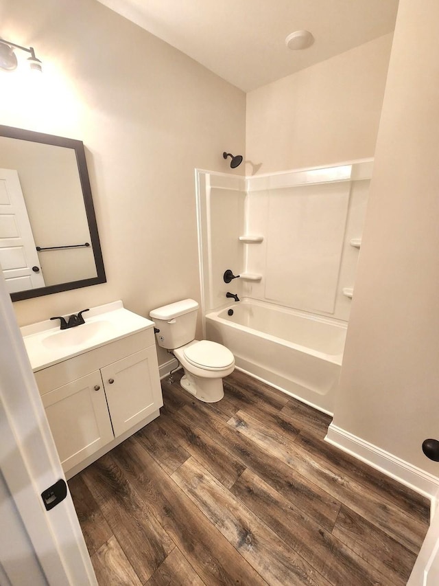 full bathroom with hardwood / wood-style flooring, vanity, toilet, and bathing tub / shower combination