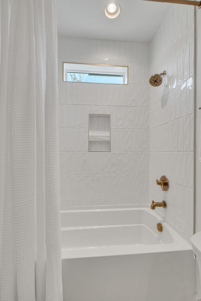 bathroom featuring shower / bath combo with shower curtain and toilet