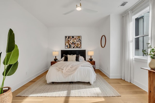 bedroom with ceiling fan and light hardwood / wood-style floors