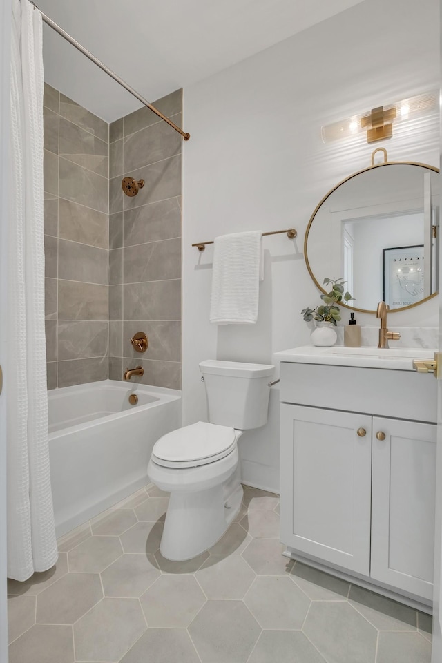 full bathroom featuring tile patterned floors, shower / bath combo with shower curtain, vanity, and toilet