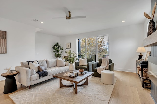 living room featuring ceiling fan and light wood-type flooring