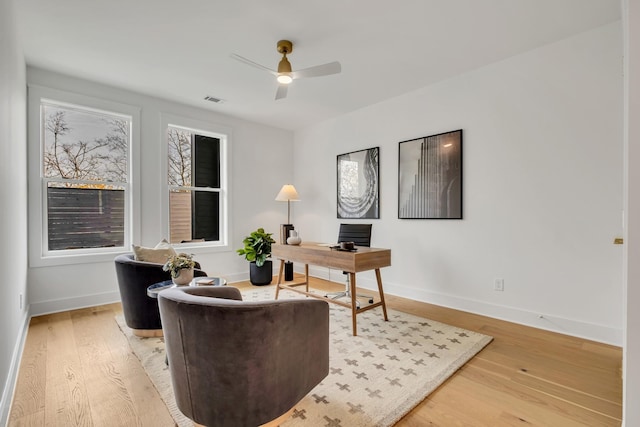 office space with hardwood / wood-style floors and ceiling fan