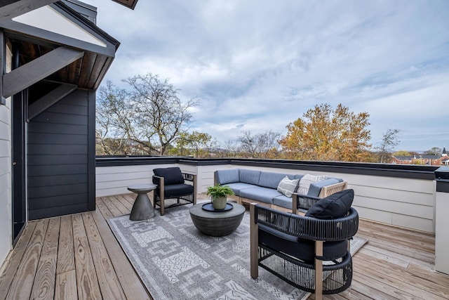 wooden terrace with an outdoor living space