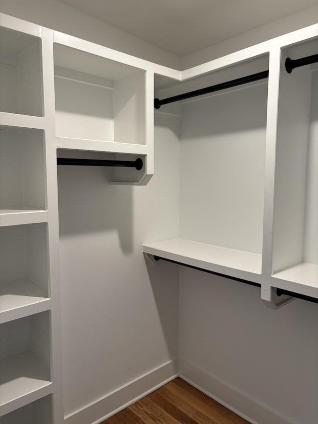 walk in closet featuring dark wood-type flooring