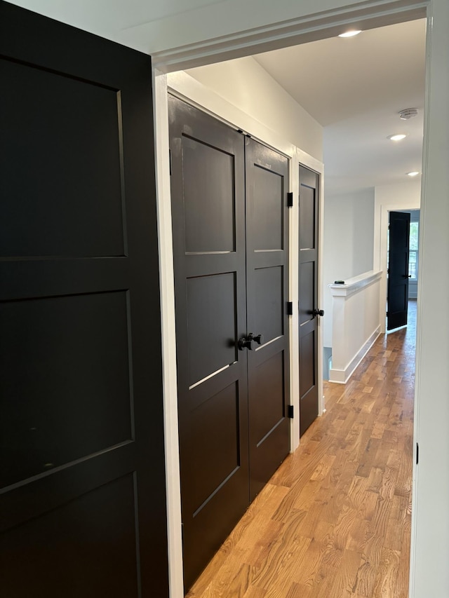 corridor with light hardwood / wood-style floors