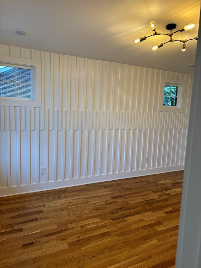 unfurnished room with hardwood / wood-style flooring