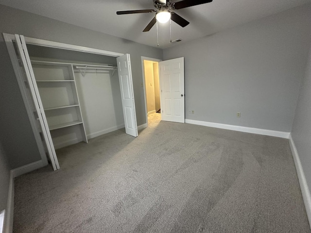 unfurnished bedroom featuring carpet floors, ceiling fan, and a closet