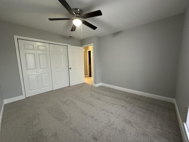 unfurnished bedroom featuring a closet, ceiling fan, and carpet