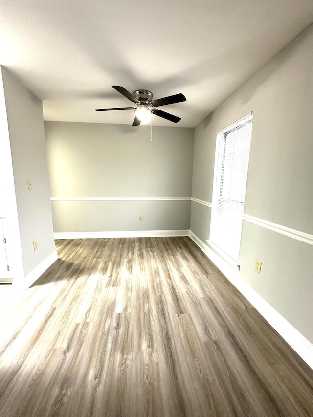 spare room with ceiling fan and light wood-type flooring