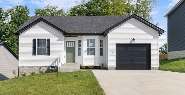 view of front facade with a front yard and a garage