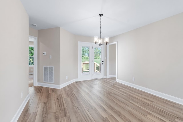 interior space with light hardwood / wood-style flooring and a notable chandelier