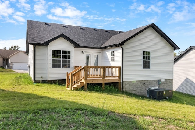 rear view of property featuring a yard, a wooden deck, french doors, and central AC unit